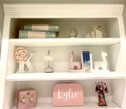 size large box placed on a white bookcase as decor
